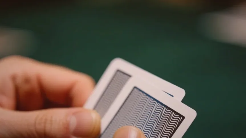 Numbered brass tokens beside a fresh deck